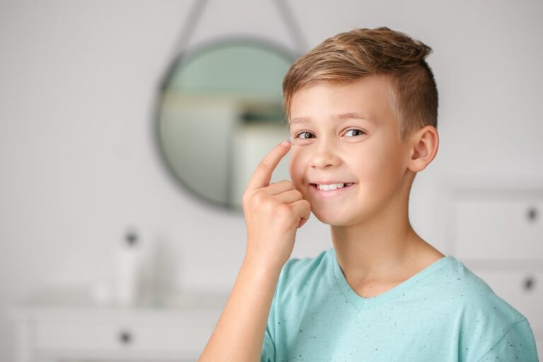 Little boy putting in a contact lens. Myopia Control for kids